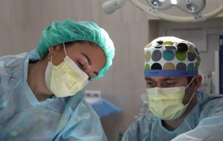 two surgeons perform labiaplasty surgery